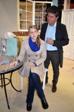 Kyra Hollis sitting at a table with Tom Sergeant standing behind her