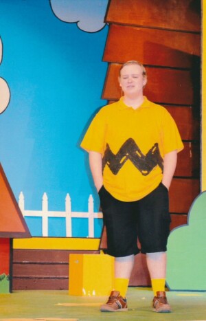 Charlie Brown standing with hands in pockets