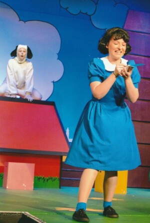 Lucy doing something nasty while Snoopy looks on in shock