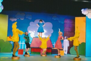 Song and dance routine with Lucy standing on Snoopys kennel and other cast gathered around