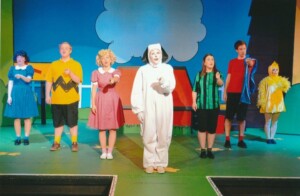 Cast on stage singing a song