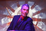 Image of Mark Fitzpatrick as Chief sitting at his desk on stage