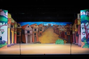 The set of Jack and the Beanstalk showing a painted village scene