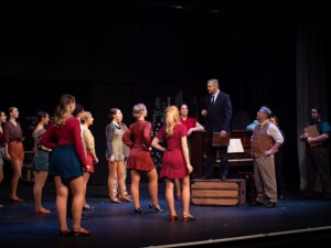 Julian (David Wallace) talking to the dancers